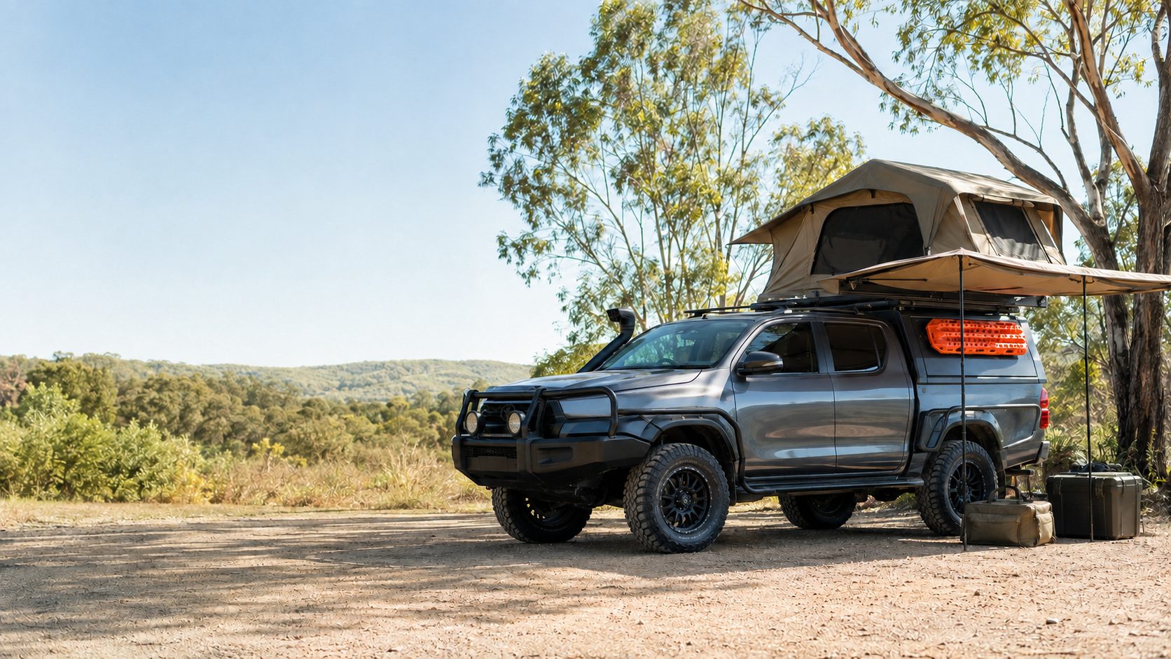Four-wheel-drive vehicle set up with a roof-top tent at a Queensland campsite